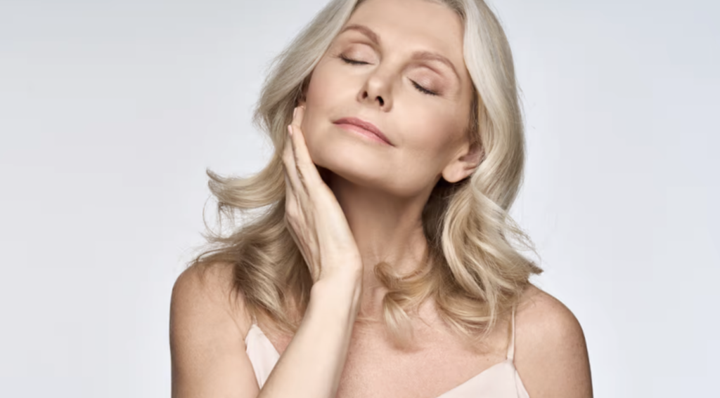 Mature woman touching face Mature woman touching face