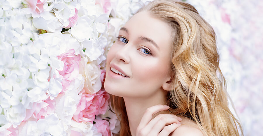 Young woman in bed of flowers Young woman in bed of flowers